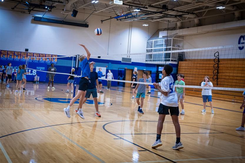 Students play volleyball in PE